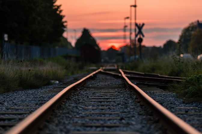 shallow focus photography of railway during sunset